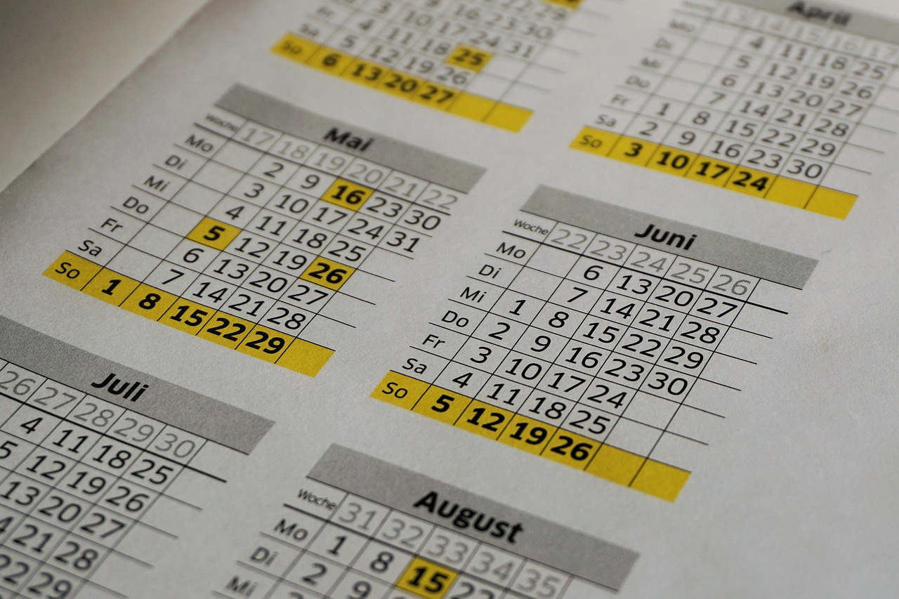 Annual wall calendar pinned in an office showing planning notes and highlighted event dates